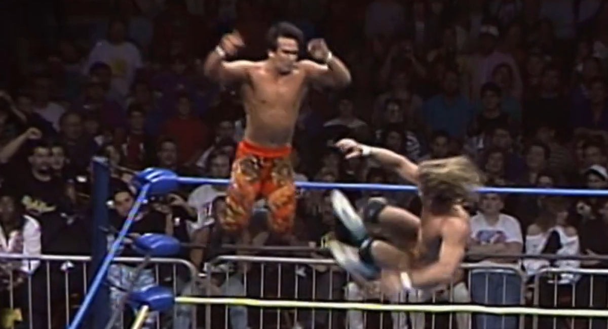 Brian Pillman catches Ricky Stemaboat mid-air with a diving dropkick.