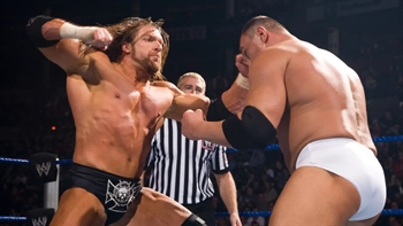 Triple H winds up for a punch on Kozlov.