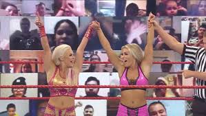 With smiles, Dana Brooke and Mandy Rose celebrate a match win.