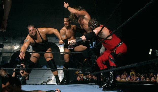 Team WWE's members all keenly reach out a hand for the tag.