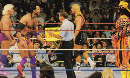 In the ring, Razor Ramon and Ric Flair jaw-jack whilst standing opposite Mr Perfect and Randy Savage.