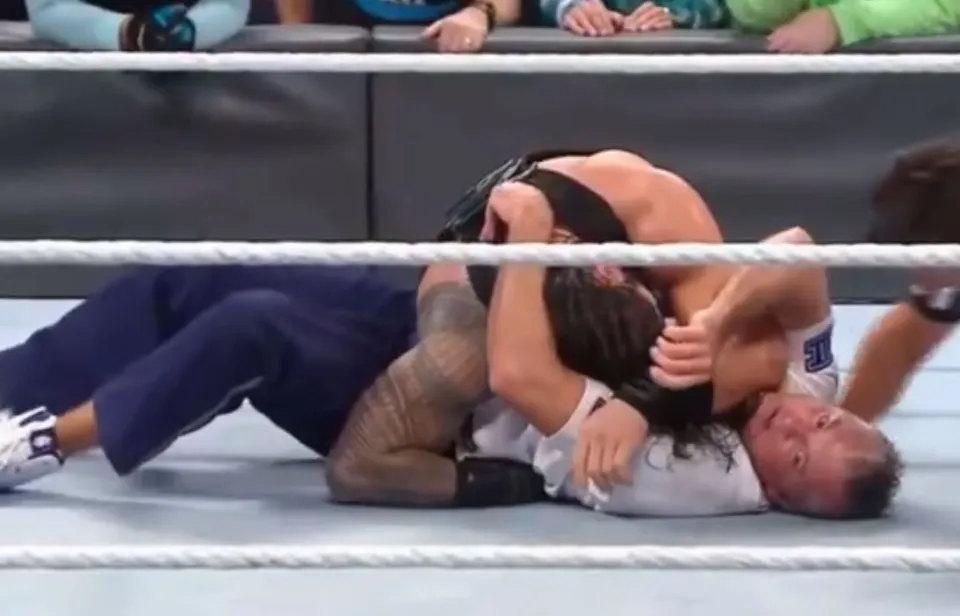 A glazy-eyed Shane McMahon is injured on the mat.