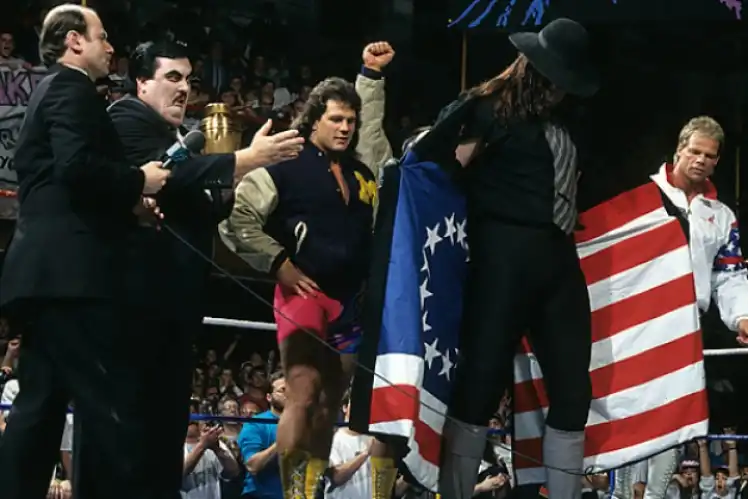 The Undertaker opens his coat to reveal a Betsy Ross US flag.
