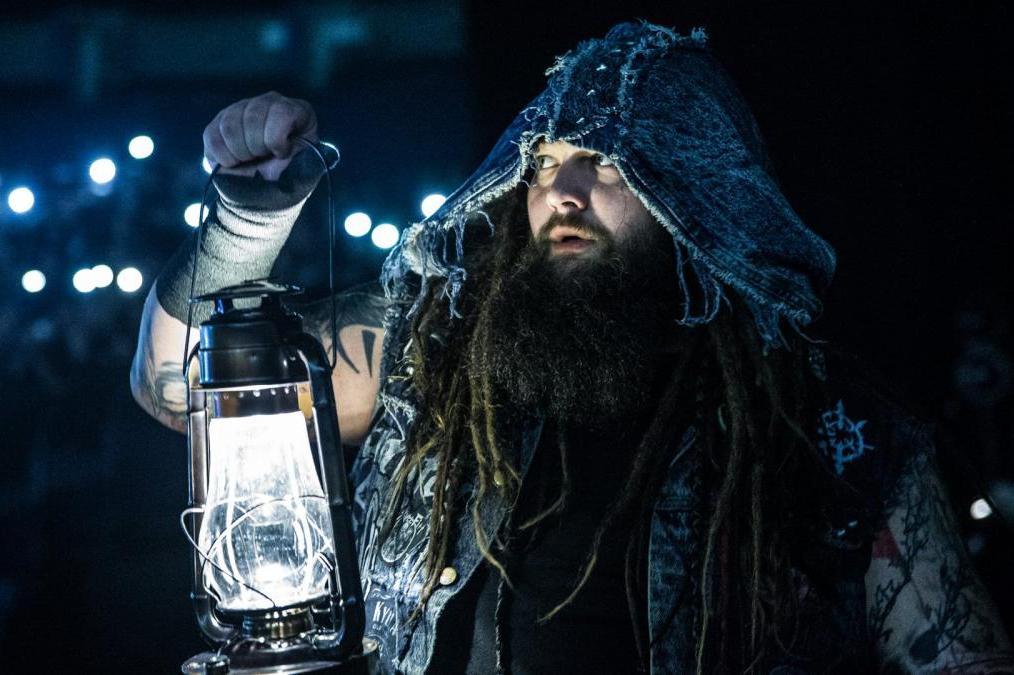 Bray Wyatt, lantern in hand and hood over head, makes his way to the ring