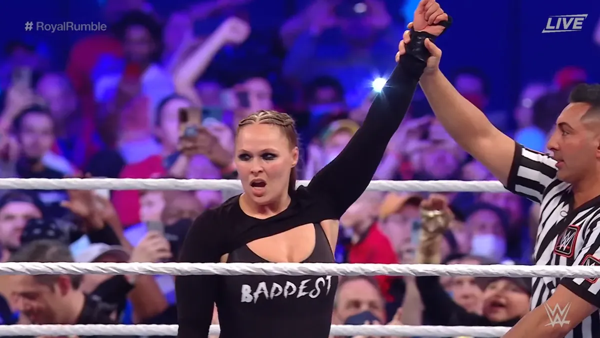 Ronda has her hand raised after winning the Royal Rumble.