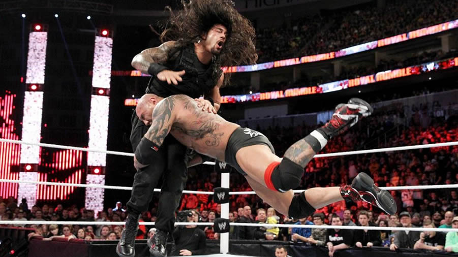 Batista delivers a Spear to Roman Reigns in the 2014 Royal Rumble.