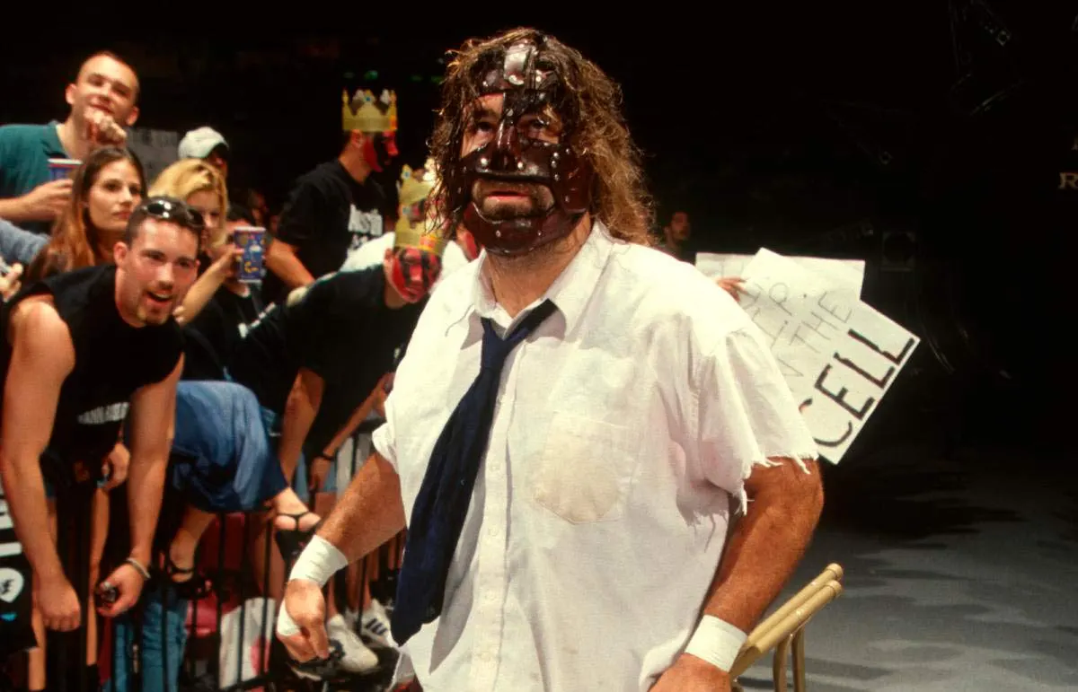 Mankind, with a gormless expression, walks to the ring.