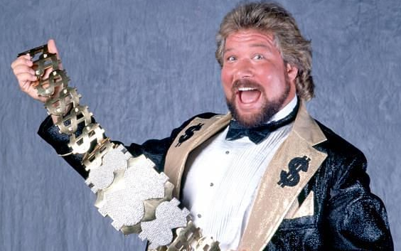 Ted Dibiase, mouth open, poses with the Million Dollar championship belt.