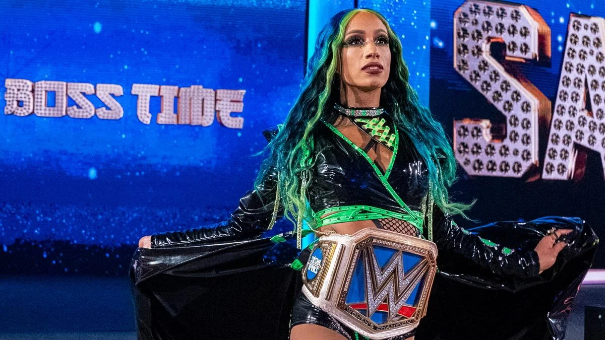 Sasha Banks walks to the ring with the SmackDown Women's championship.
