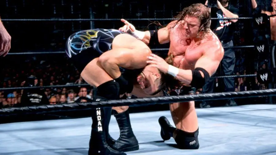 Triple H delivers his patented knee smash to Rob Van Dam.