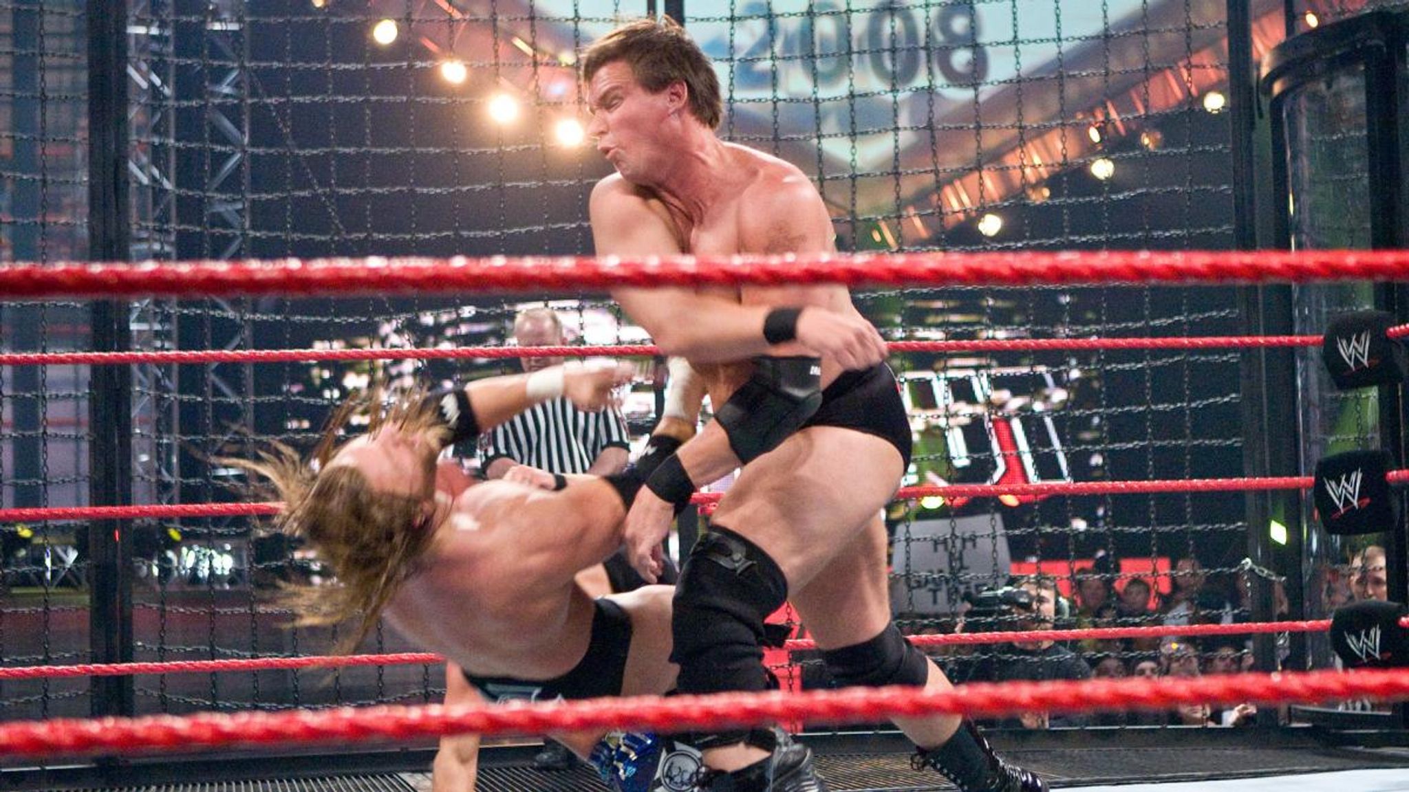 JBL lays out Triple H with a massive Clothesline from Hell.
