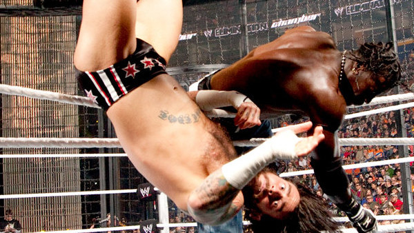 R-Truth clotheslines CM Punk over the top rope.